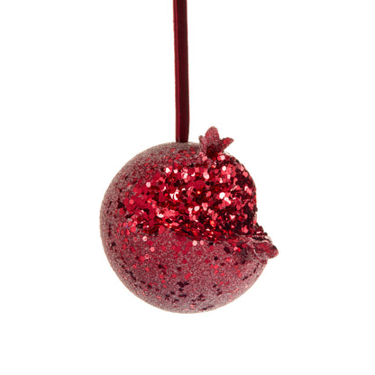 Iced Pomegranate Ornament, A red glitter ornament shaped like a pomegranate with a crowned top, hanging from a burgundy ribbon.