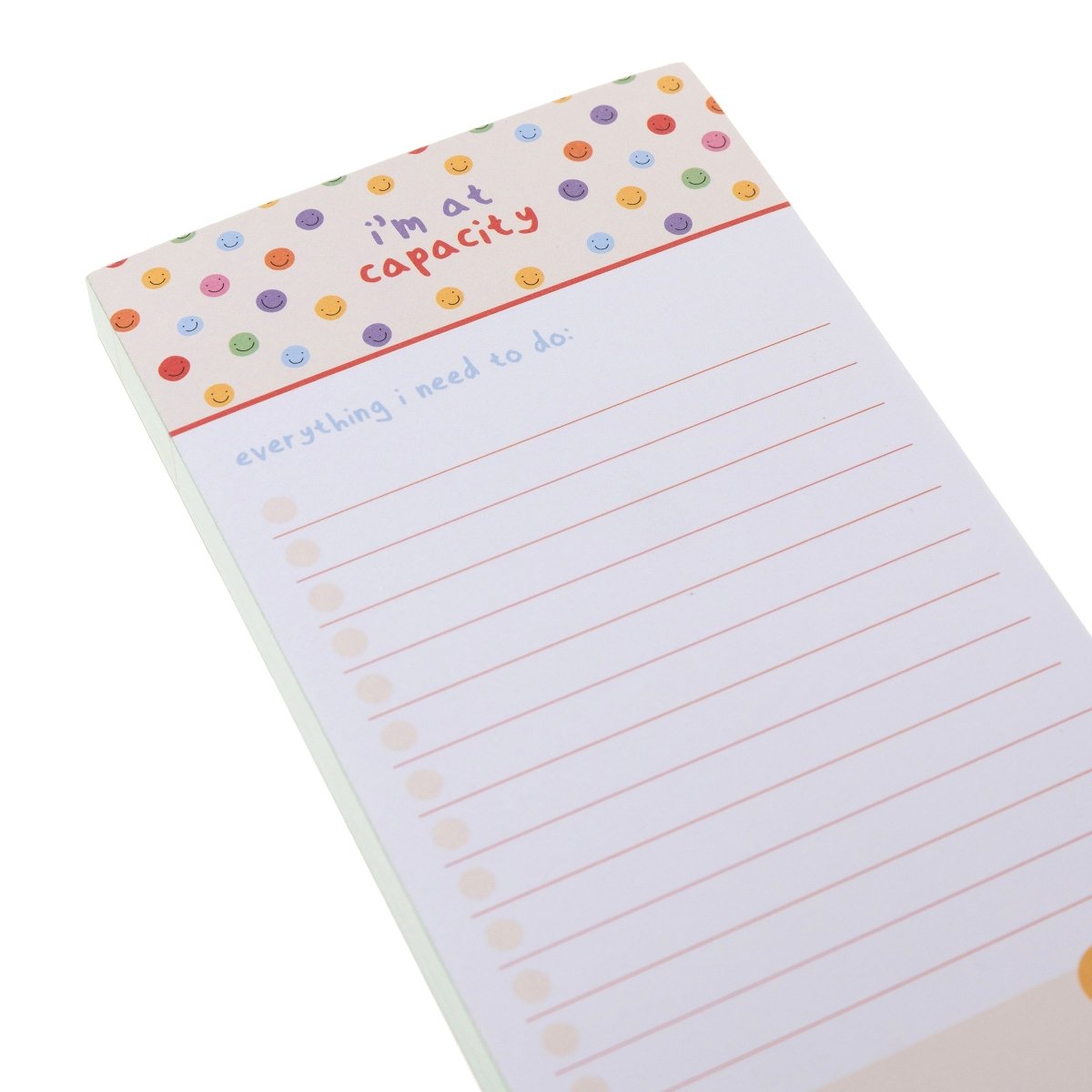 I'm At Capacity Magnetic Notepad, A tall magnetic notepad printed 'i'm at capacity' with colorful smiley polka dots above a lined checklist and a 'random notes' section.