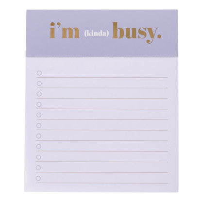 I'm Busy Jotter Notepad, A lavender-topped jotter notepad printed with 'i'm (kinda) busy' in gold foil above lined, checkbox-style pages.