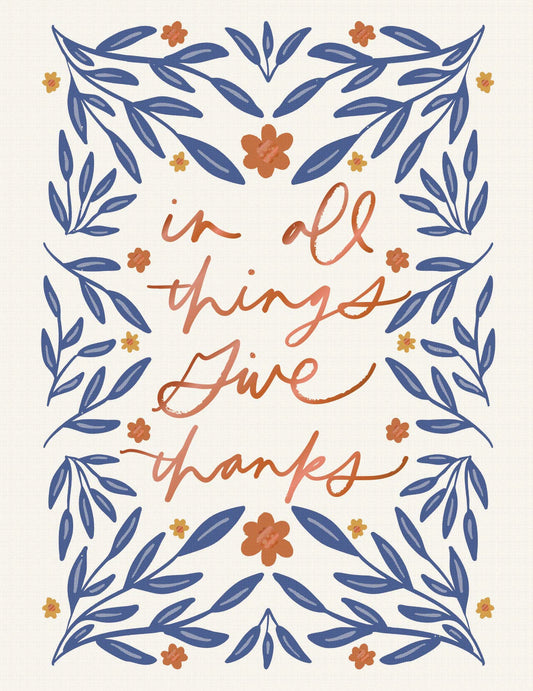 In All Things Greeting Card, A cream card front with the words in all things give thanks in copper script, framed by a symmetrical border of navy leaf sprigs and orange and mustard flowers.