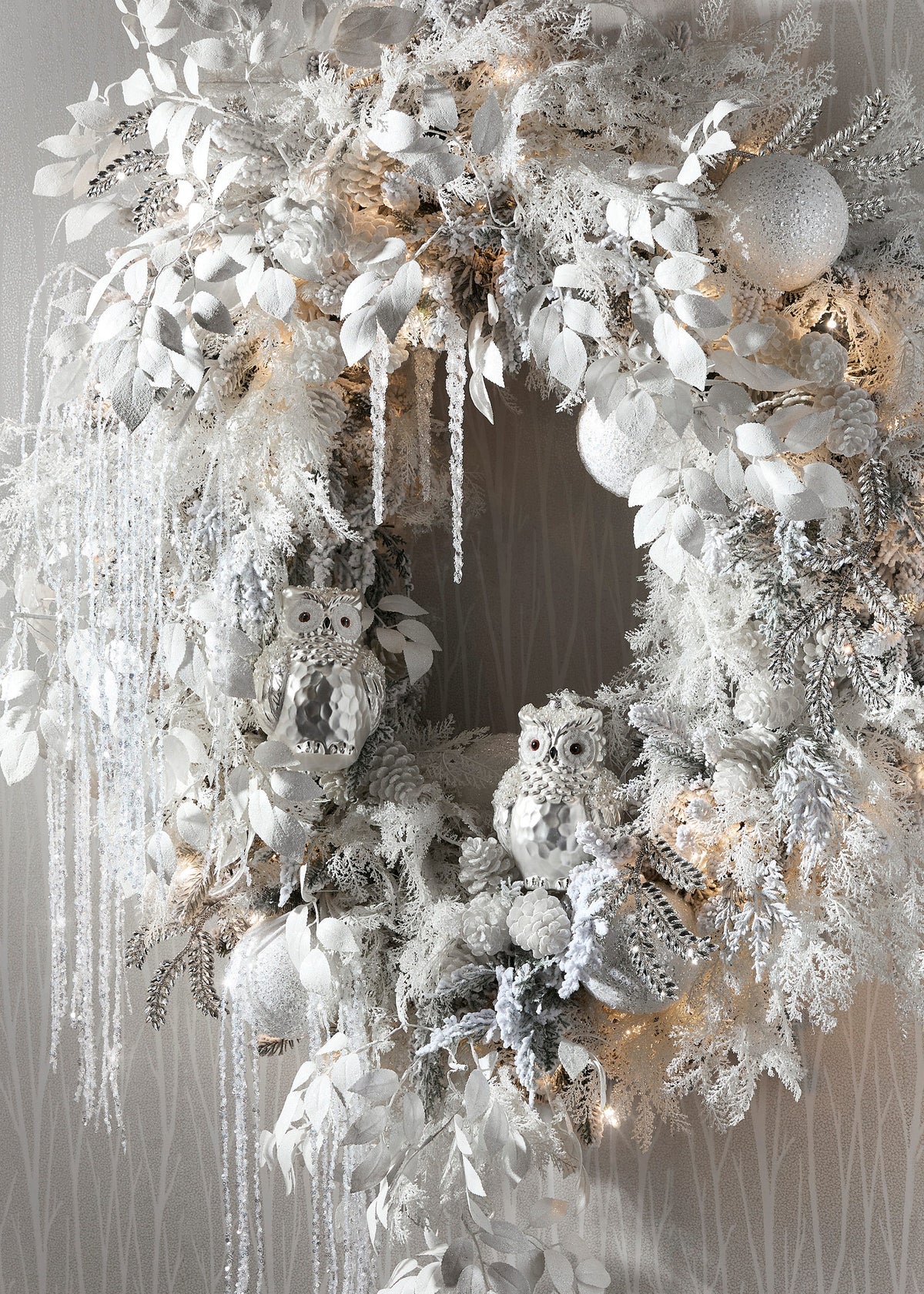 Jeweled Snowy Owl Ornament, A pearlescent white glass owl ornament with glittered eyes and clusters of pearl beading on its wings.