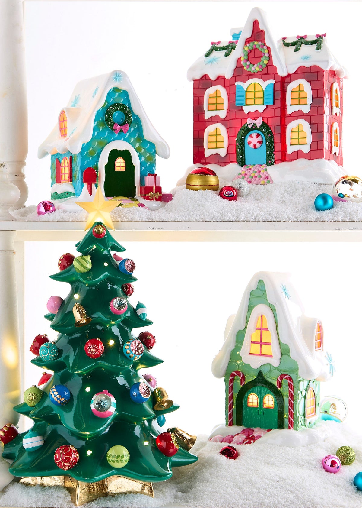 Lighted Tabletop Christmas Tree with Ornaments, A glossy green tabletop Christmas tree dotted with small lights and ornaments in red, pink and teal, with gold bells, a gold star on top and a gold star-shaped base.