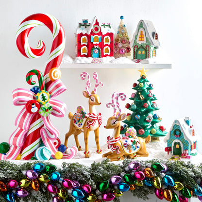 Lighted Tabletop Christmas Tree with Ornaments, A glossy green tabletop Christmas tree dotted with small lights and ornaments in red, pink and teal, with gold bells, a gold star on top and a gold star-shaped base.