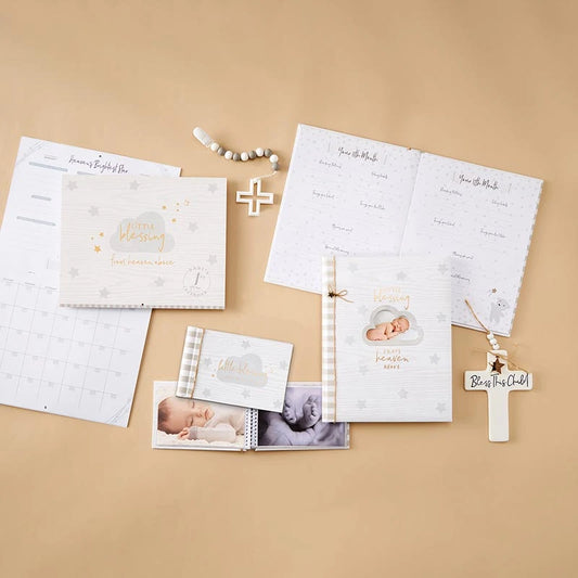 Little Blessings Baby Keepsake, The Little Blessings First Year Calendar cover is pale gray woodgrain with a gray cloud, gold script lettering, gray and gold stars and a round Baby's 1st Year Calendar seal.