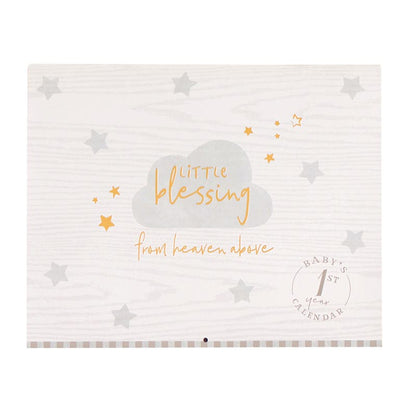 Little Blessings Baby Keepsake, The Little Blessings First Year Calendar cover is pale gray woodgrain with a gray cloud, gold script lettering, gray and gold stars and a round Baby's 1st Year Calendar seal.