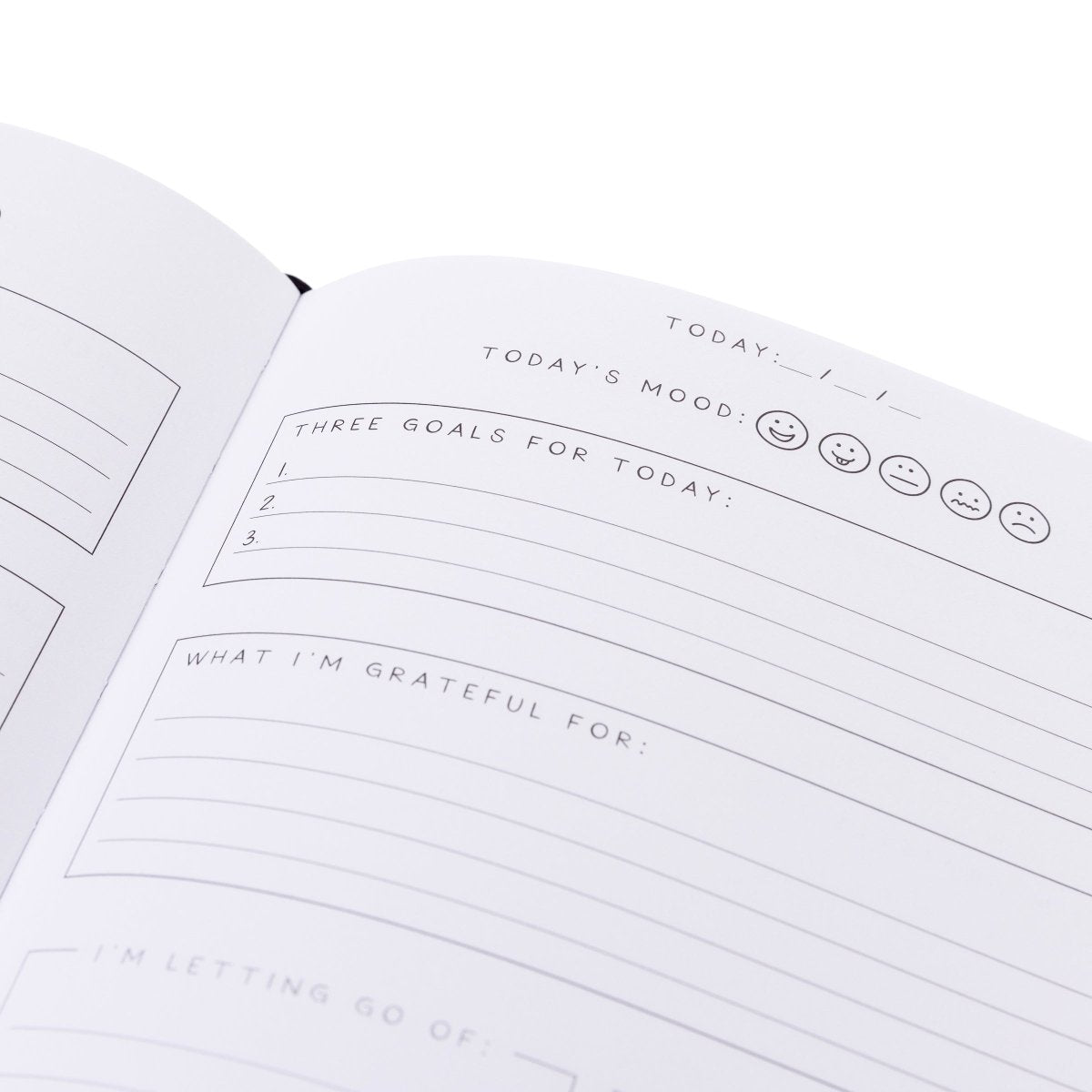 Manifest Self-Care Journal, A periwinkle blue fabric journal printed with celestial suns, moons, and stars under 'Manifest Your Dreams' in gold foil.