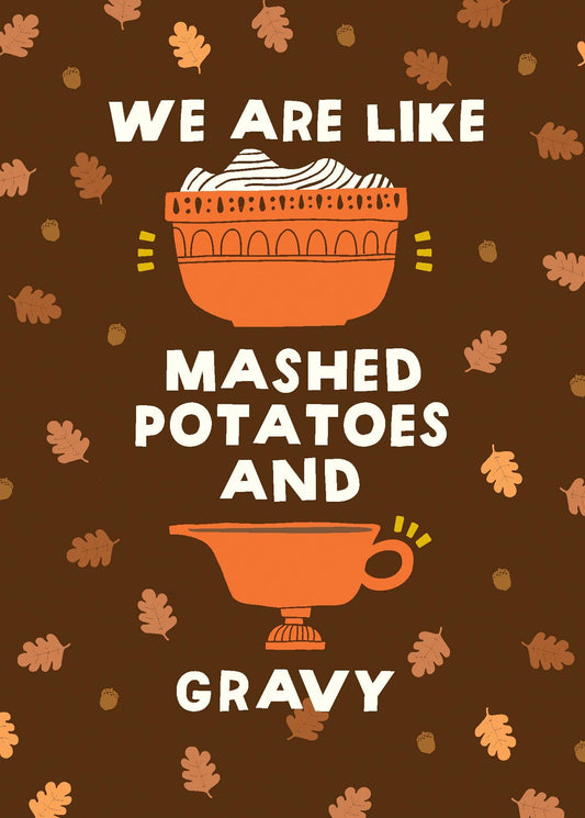 Mashed Potatoes and Gravy Greeting Card, Front of a deep brown card with cream hand-cut lettering that says WE ARE LIKE MASHED POTATOES AND GRAVY around an orange bowl of mashed potatoes and an orange gravy boat, with oak leaves and acorns scattered behind.