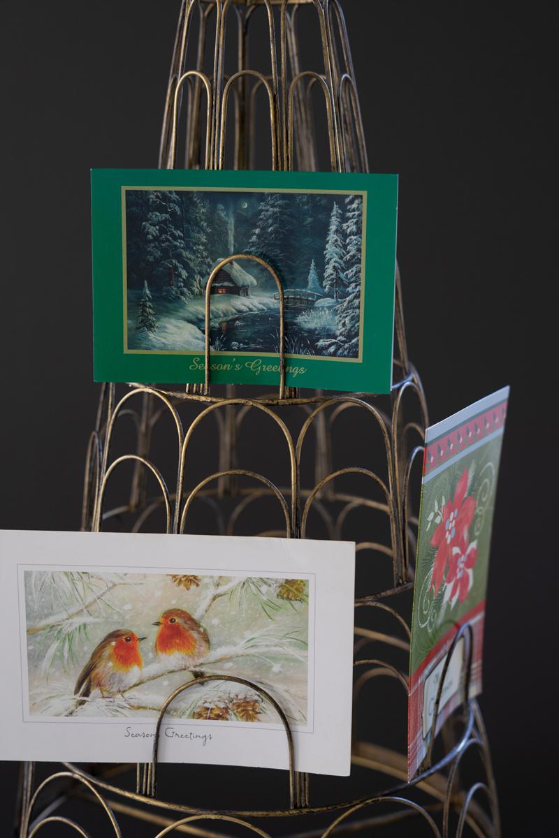 Metal Christmas Tree Card Holder, A tall metal Christmas tree shaped card holder with a star on top and slots along each level.