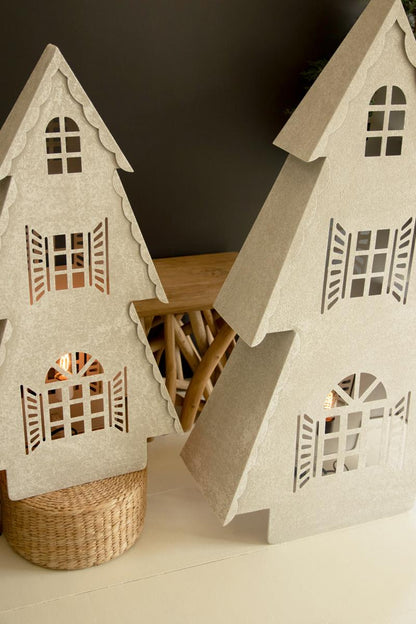 Metal Christmas Village Lamp, Two illuminated metal Christmas village house lamps, one large and one small, glowing from inside.