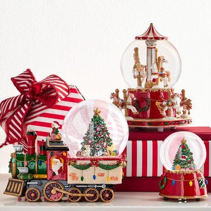 Animated Musical Christmas Tree Snow Globe, A snow globe holding a decorated Christmas tree and wrapped presents in white snow, on a red base with gold scrollwork, a wreath and colored bulbs.