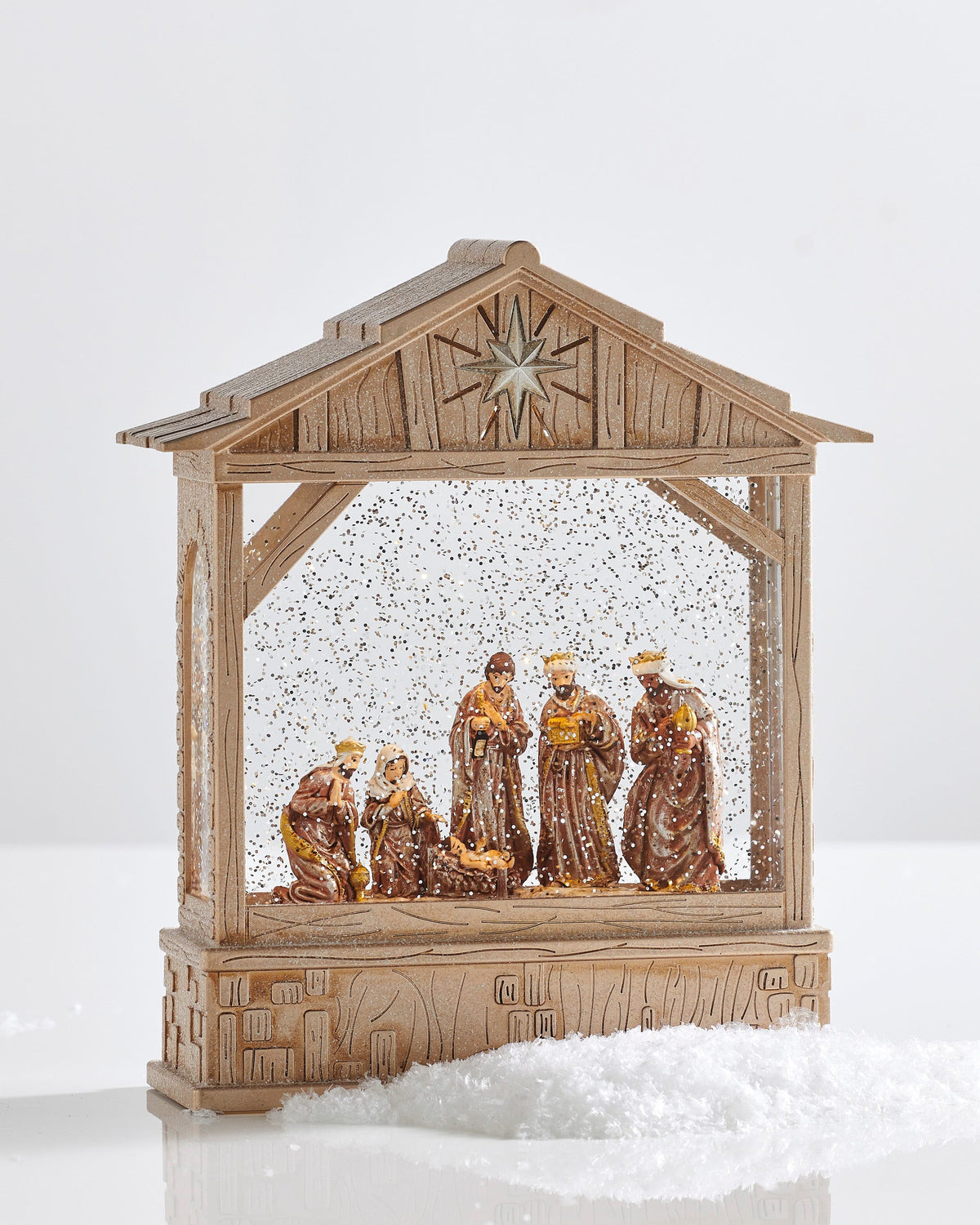 Nativity Musical Lighted Water Creche, A nativity water lantern in a wood-look stable frame with swirling glitter around the Holy Family and the three wise men figures.