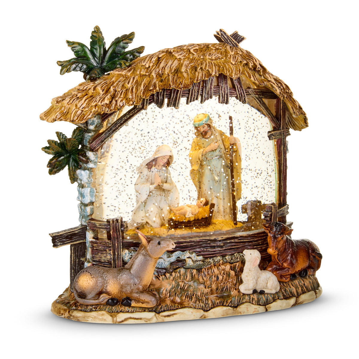 Nativity Stable Lighted Water Lantern, A resin nativity stable with a thatched roof and palms, Mary and Joseph at the manger behind glittered water, and a donkey, a lamb and an ox resting on the base.