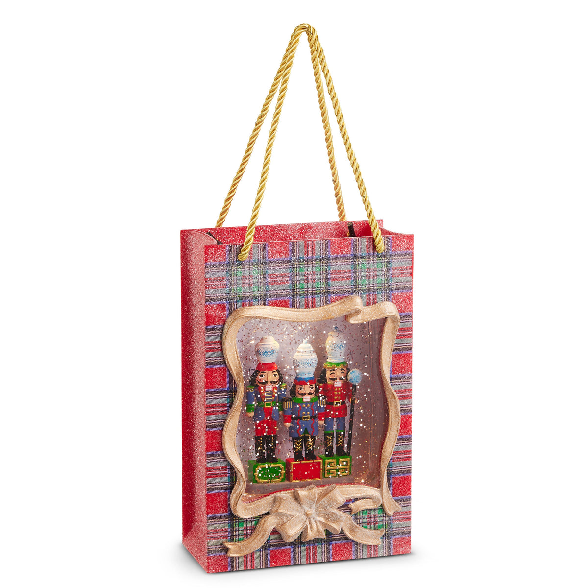 Noble Nutcracker Lighted Water Present, A red plaid gift-bag-shaped lantern with gold rope handles and a gold ribbon frame, showing three nutcrackers each topped with a blue-and-white ginger jar amid glitter.