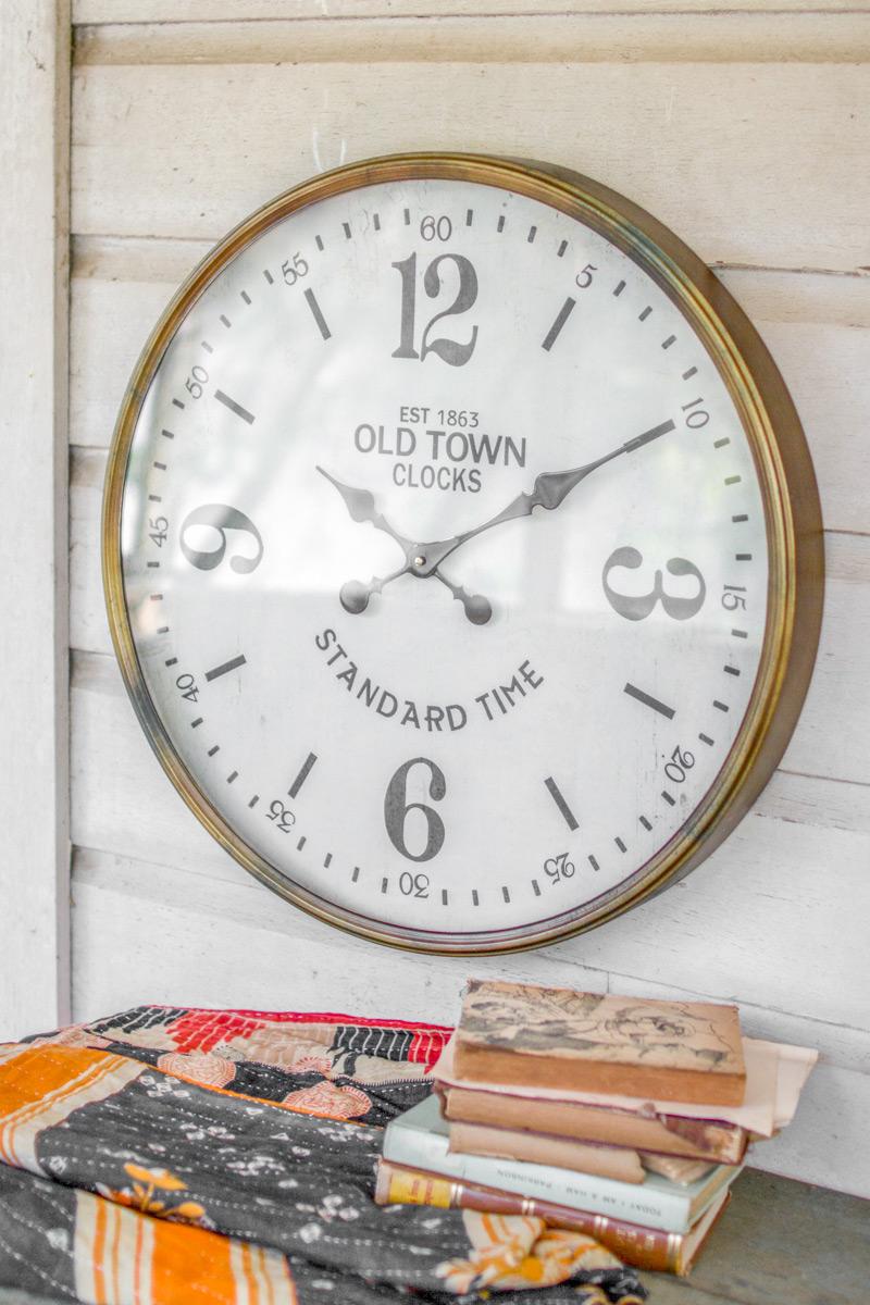 Old Town Station Clock, A large round station style wall clock with a glass face and brass metal detail.