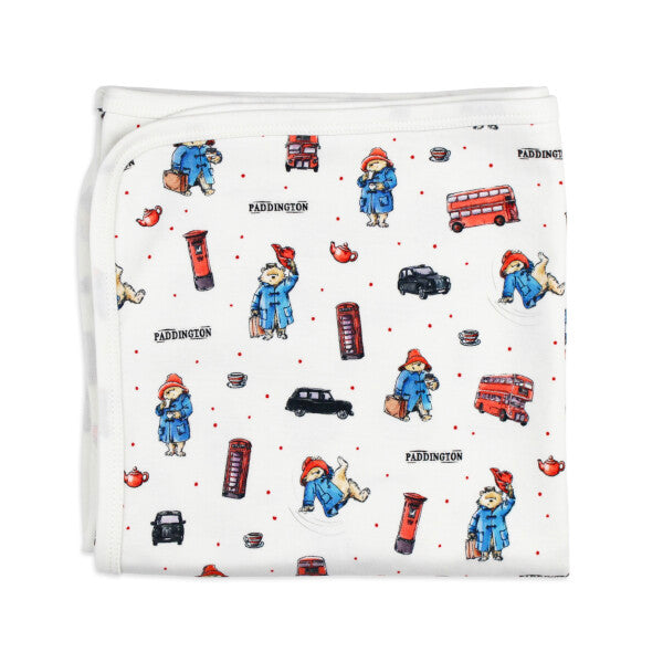 Organic Cotton Baby Blanket, London Paddington Print, A folded white cotton baby blanket printed with illustrations of Paddington Bear, London buses, telephone booths, and post boxes.