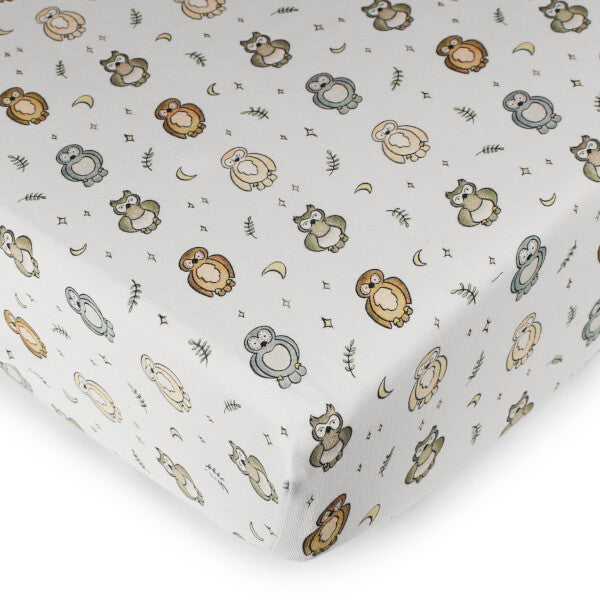 Organic Cotton Crib Sheet, Owl Print, A fitted crib sheet in a white cotton fabric printed with a whimsical pattern of owls, moons, and stars in soft neutral tones.