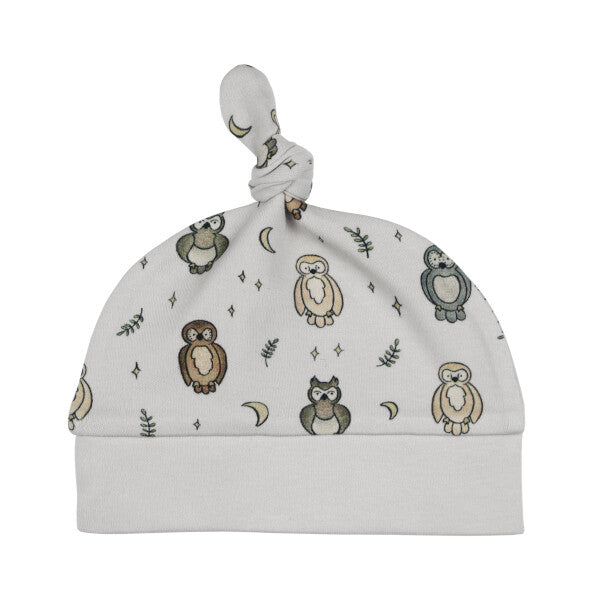 Organic Knotted Baby Hat, Owl Print, A pale gray knotted baby hat printed with owls, crescent moons, stars, and leaf sprigs, shown against a white background.