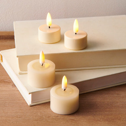 Pair of Ivory Melted Top Flameless Tealights, Two ivory flameless tealights with melted wax tops and lit flame-shaped tips, side by side on a white background.