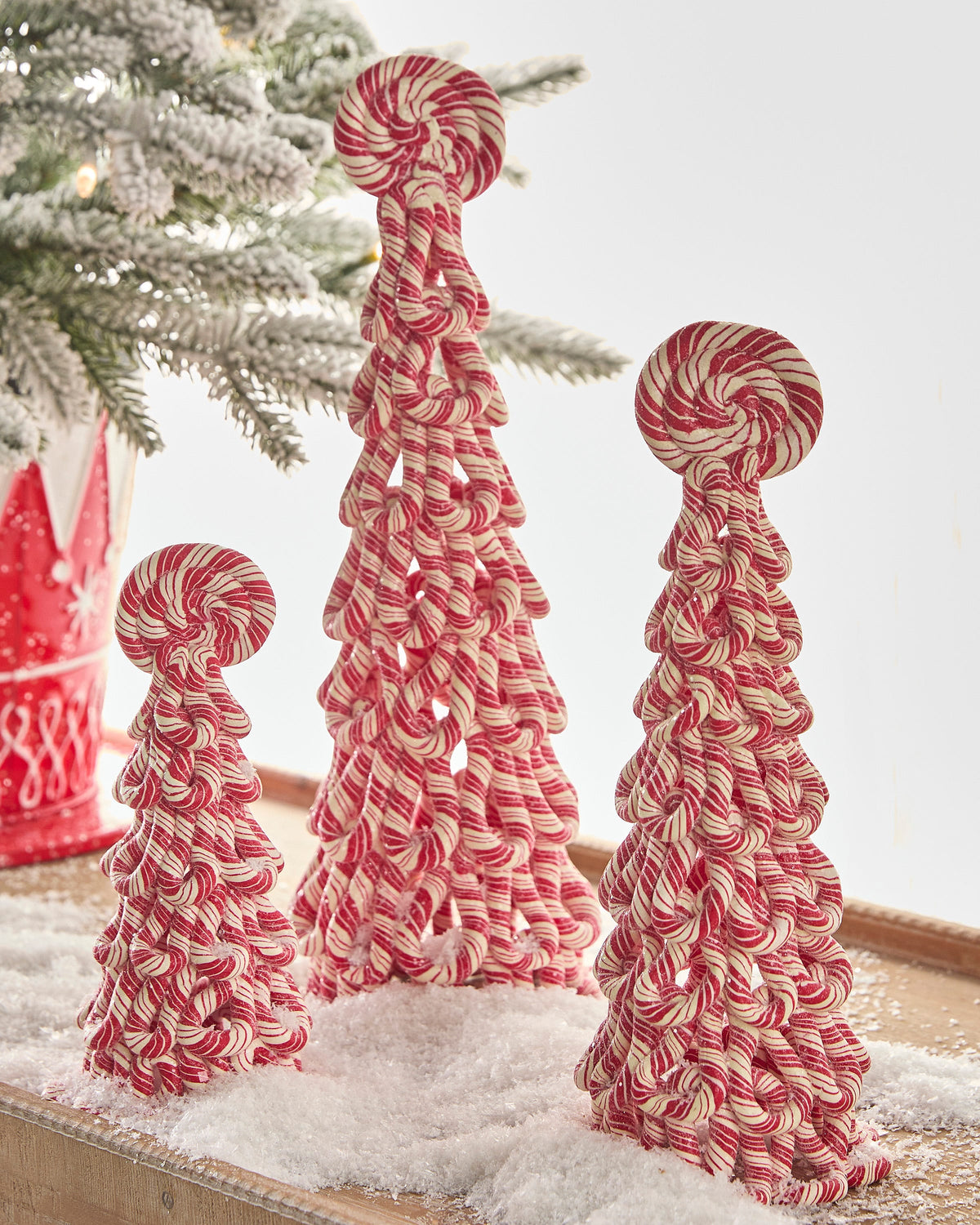 Peppermint Swirl Tabletop Christmas Tree, Small, medium and large red and white peppermint-striped cone trees side by side, each built of looped stripes and topped with a round peppermint swirl.