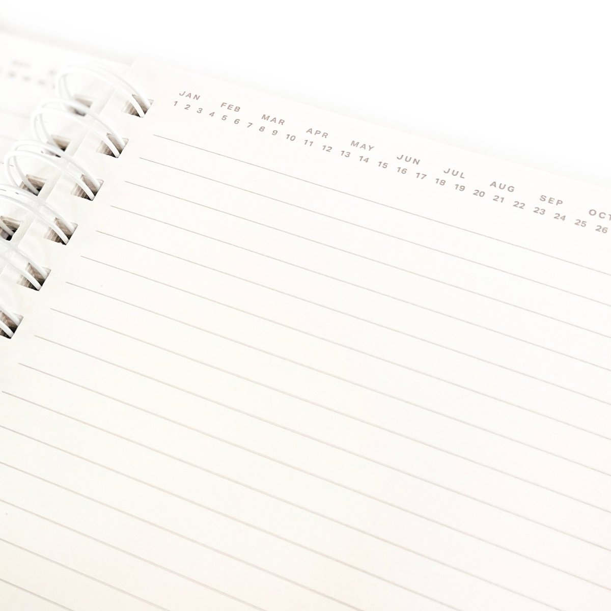 Positive Everyday Journal, A kraft brown spiral-bound journal with the words Positive Mind. Positive Life. printed in white foil script on the cover.