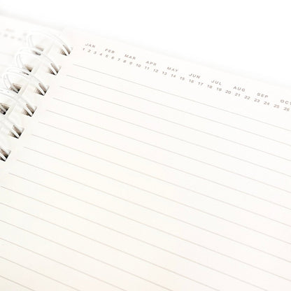 Positive Everyday Journal, A kraft brown spiral-bound journal with the words Positive Mind. Positive Life. printed in white foil script on the cover.