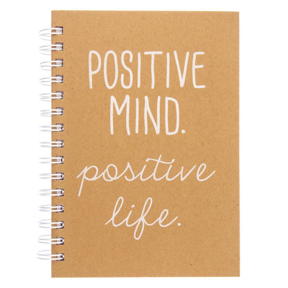Positive Everyday Journal, A kraft brown spiral-bound journal with the words Positive Mind. Positive Life. printed in white foil script on the cover.