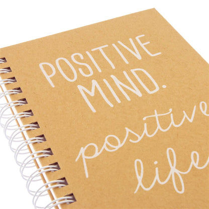 Positive Everyday Journal, A kraft brown spiral-bound journal with the words Positive Mind. Positive Life. printed in white foil script on the cover.