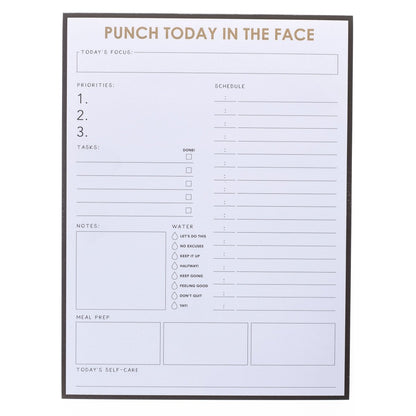 Punch Today Large Notepad, A black-bordered notepad printed 'Punch Today In The Face' in gold foil above sections for priorities, schedule, water, meals, and self-care.