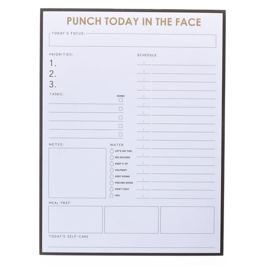 Punch Today Large Notepad, A black-bordered notepad printed 'Punch Today In The Face' in gold foil above sections for priorities, schedule, water, meals, and self-care.