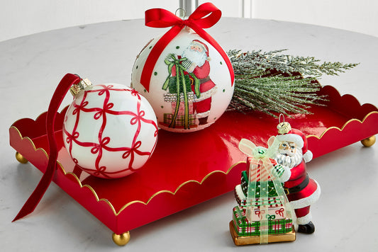Red Scalloped Tray with Gold Trim, A rectangular red tray with a scalloped rim edged in gold, standing on gold ball feet.