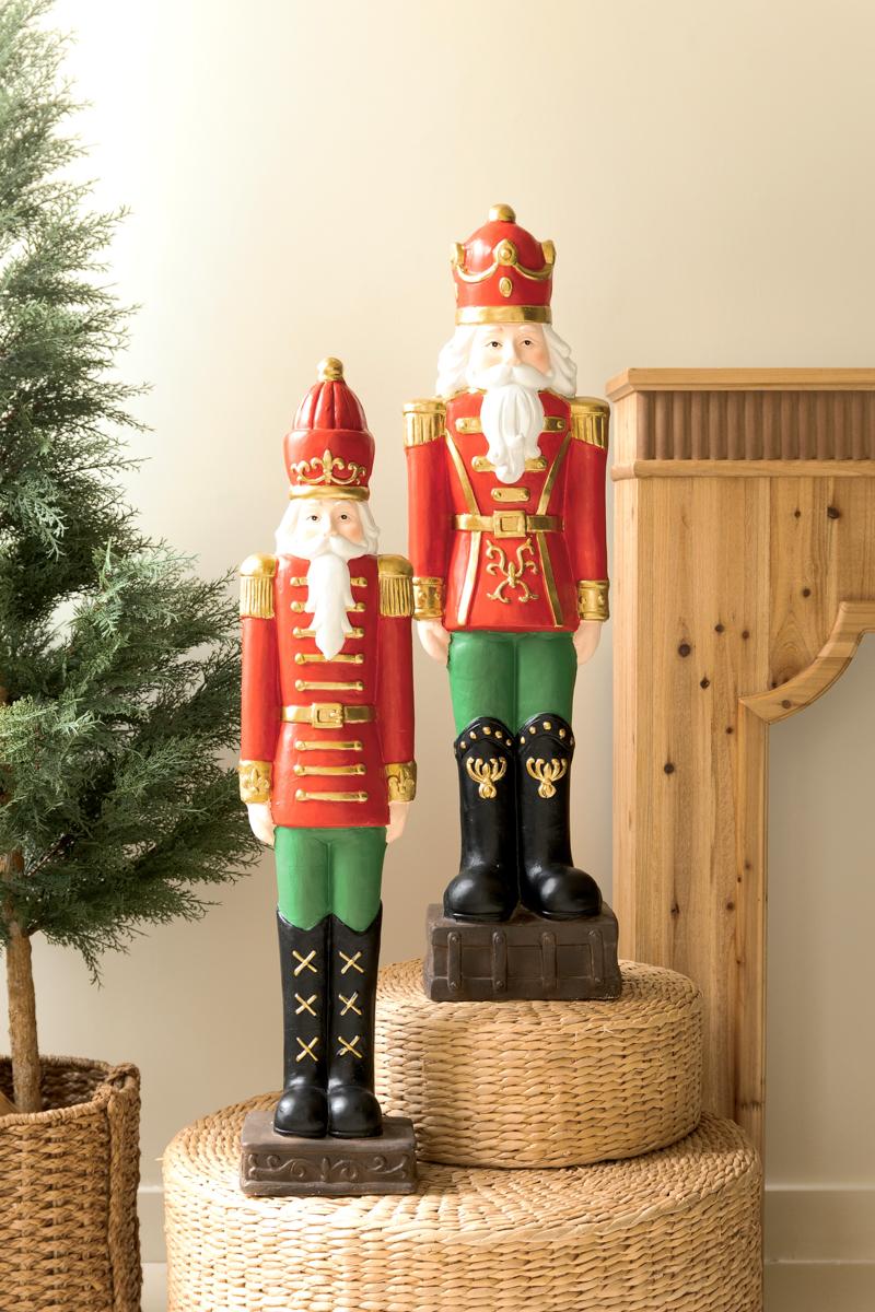 Resin Christmas Soldier, Two tall painted resin toy soldier figures in red uniforms, one slightly taller than the other.
