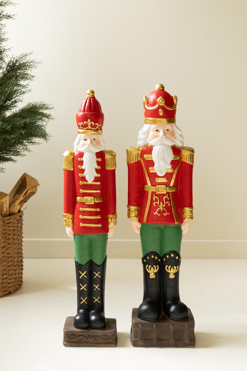 Resin Christmas Soldier, Two tall painted resin toy soldier figures in red uniforms, one slightly taller than the other.