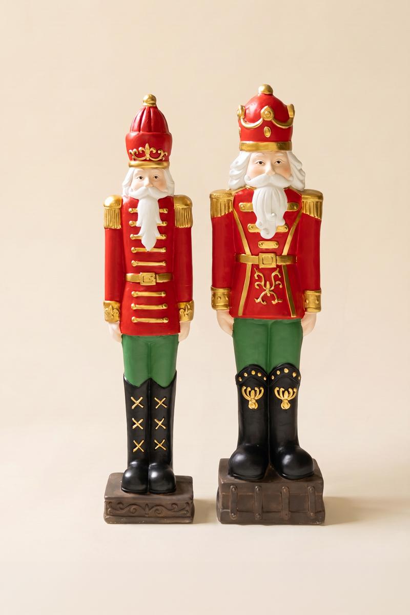 Resin Christmas Soldier, Two tall painted resin toy soldier figures in red uniforms, one slightly taller than the other.