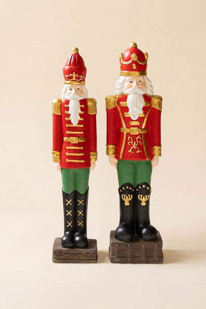 Resin Christmas Soldier, Two tall painted resin toy soldier figures in red uniforms, one slightly taller than the other.