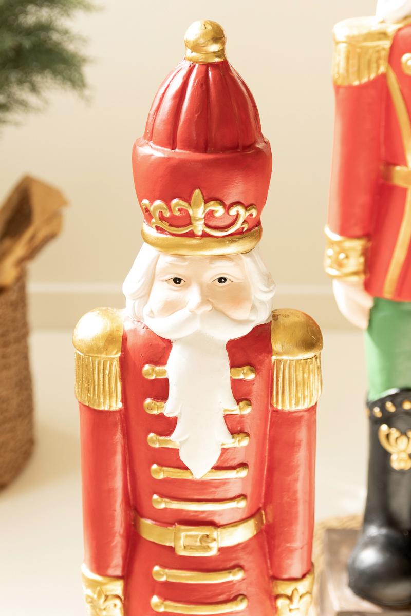 Resin Christmas Soldier, Two tall painted resin toy soldier figures in red uniforms, one slightly taller than the other.