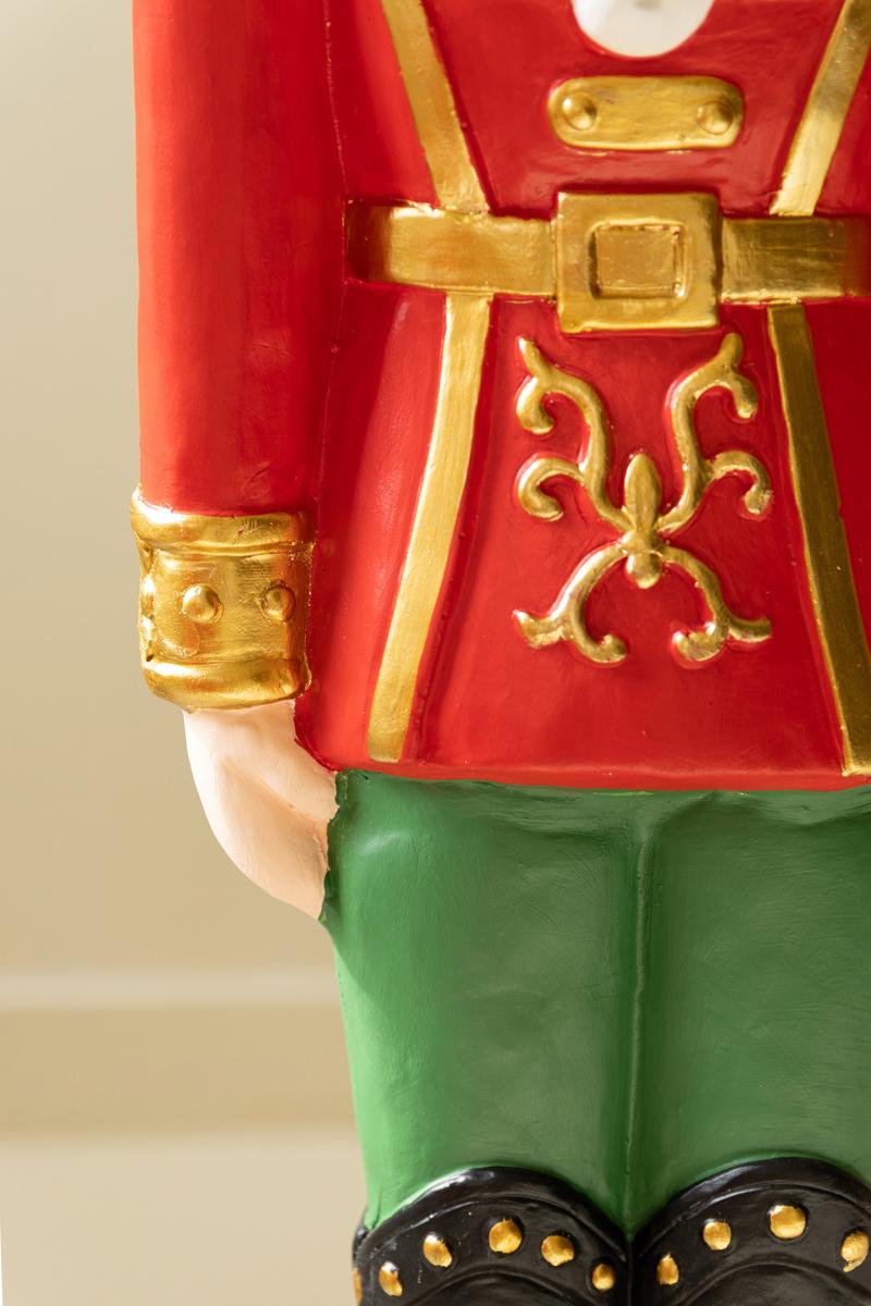 Resin Christmas Soldier, Two tall painted resin toy soldier figures in red uniforms, one slightly taller than the other.