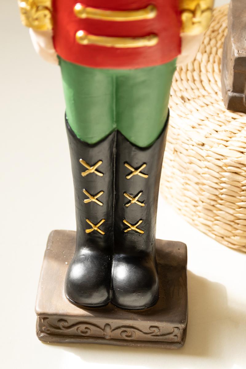 Resin Christmas Soldier, Two tall painted resin toy soldier figures in red uniforms, one slightly taller than the other.