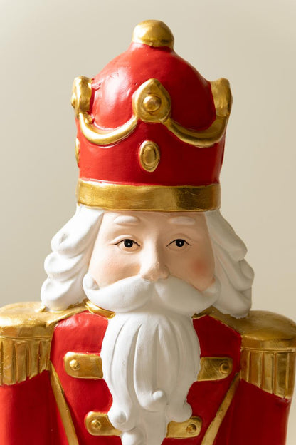 Resin Christmas Soldier, Two tall painted resin toy soldier figures in red uniforms, one slightly taller than the other.