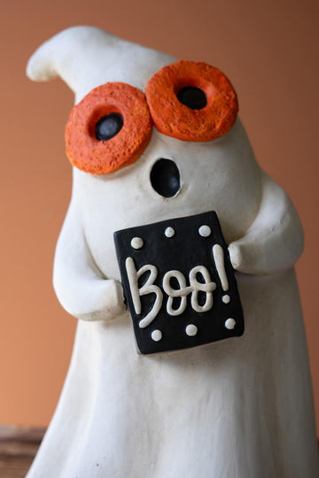 Resin Halloween Ghost, Two white resin ghost figures on a wooden crate, one wearing round orange glasses and holding a black BOO sign, the other wearing a black witch hat and holding a candy corn.