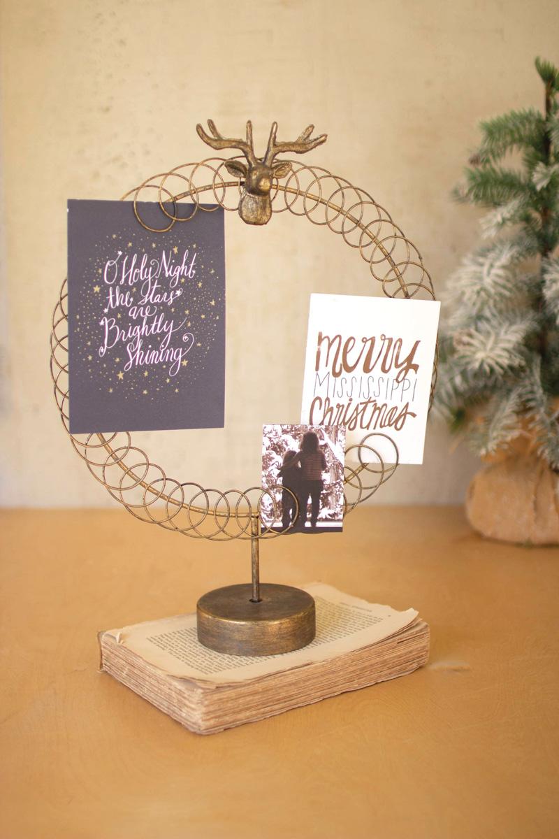 Round Wire Christmas Card Holder on a Stand, A round wire card holder on a stand with cards tucked into the wire.
