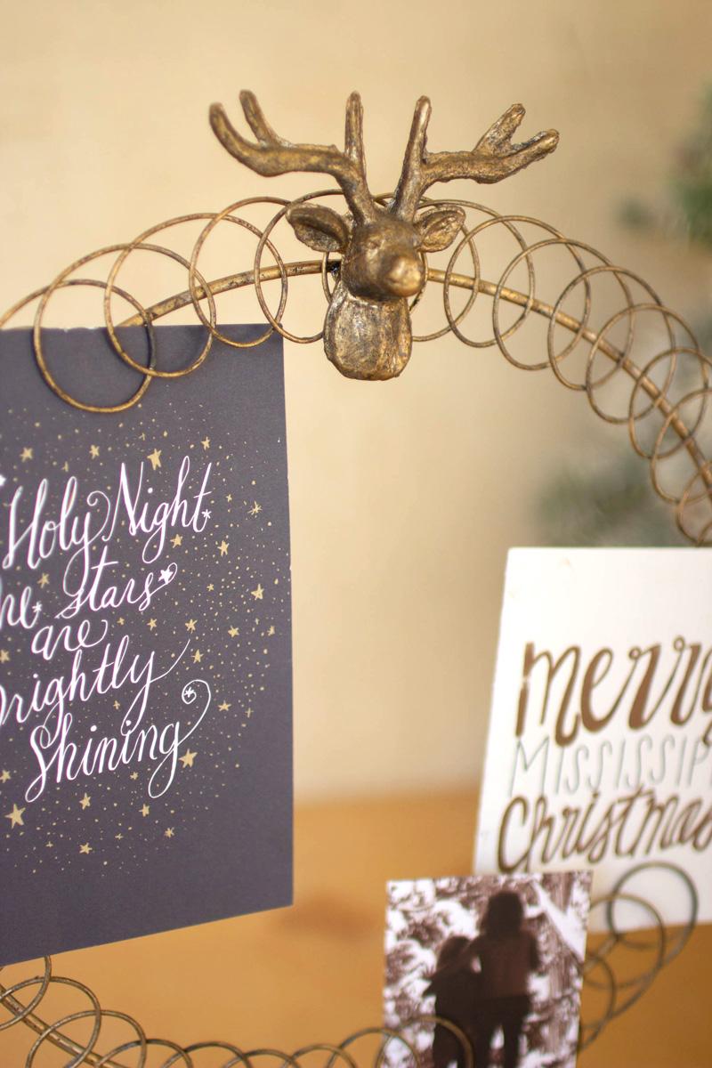 Round Wire Christmas Card Holder on a Stand, A round wire card holder on a stand with cards tucked into the wire.