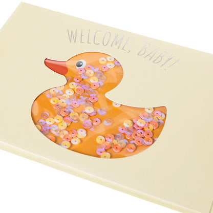 Rubber Ducky Baby Handmade Card, A cream card with a die-cut duck shape filled with iridescent sequins and Welcome, Baby! in holographic foil, shown with its envelope.