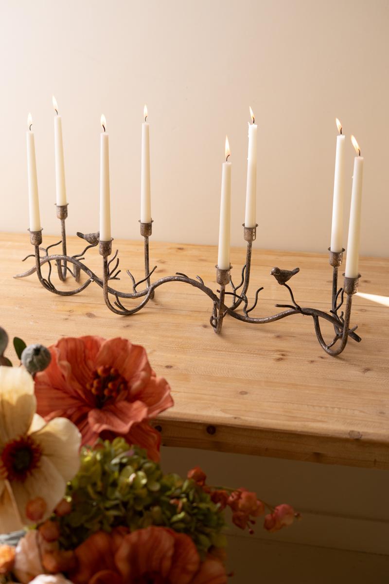 Rustic Metal Candelabra with Birds, A long curved iron candelabra with eight taper holders and two small bird figures.