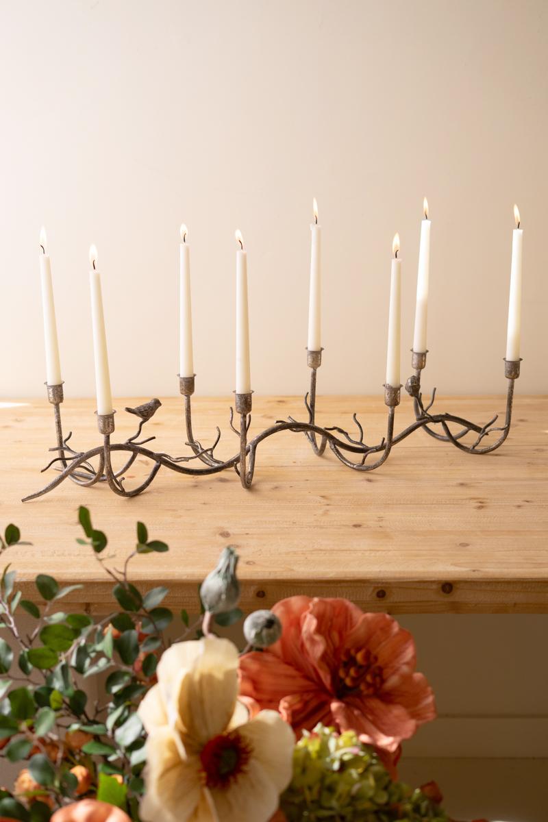 Rustic Metal Candelabra with Birds, A long curved iron candelabra with eight taper holders and two small bird figures.