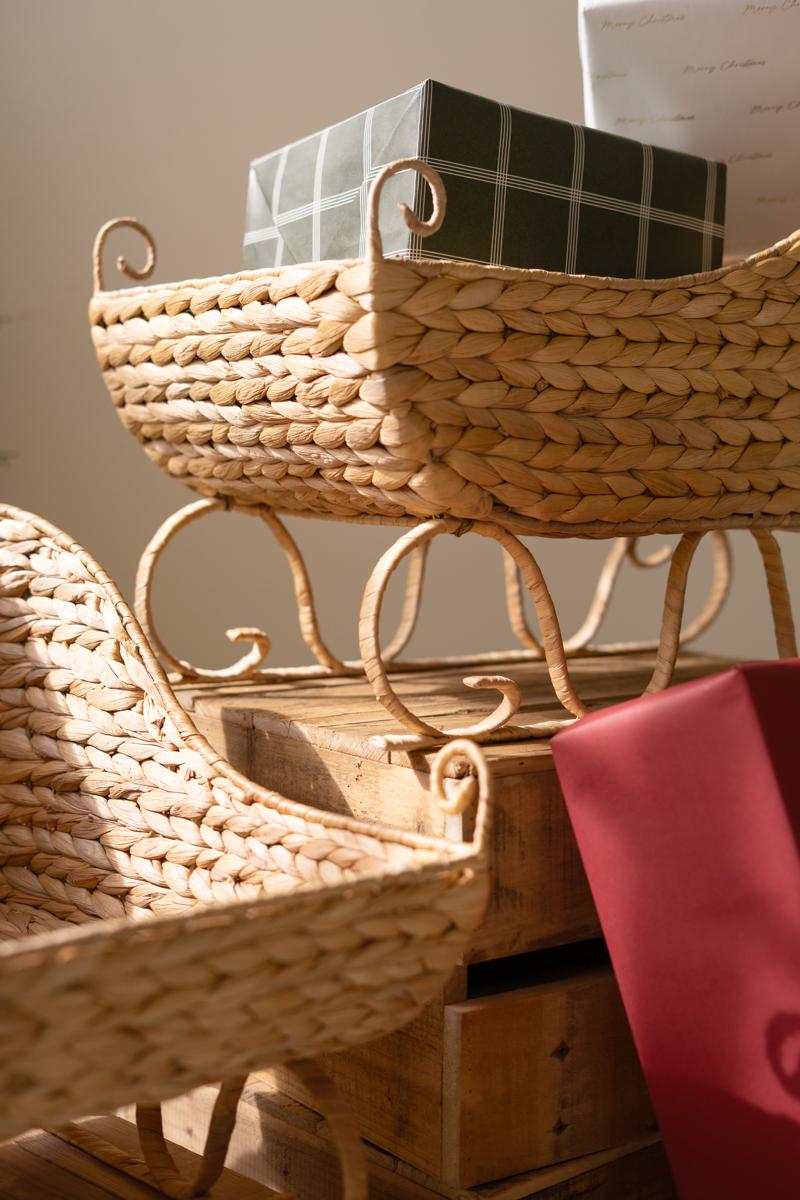 Seagrass Christmas Sleigh, Two woven sleigh shaped baskets, one large and one small, side by side.