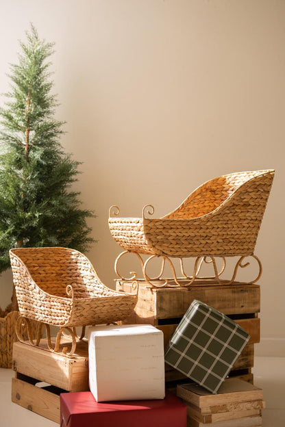 Seagrass Christmas Sleigh, Two woven sleigh shaped baskets, one large and one small, side by side.