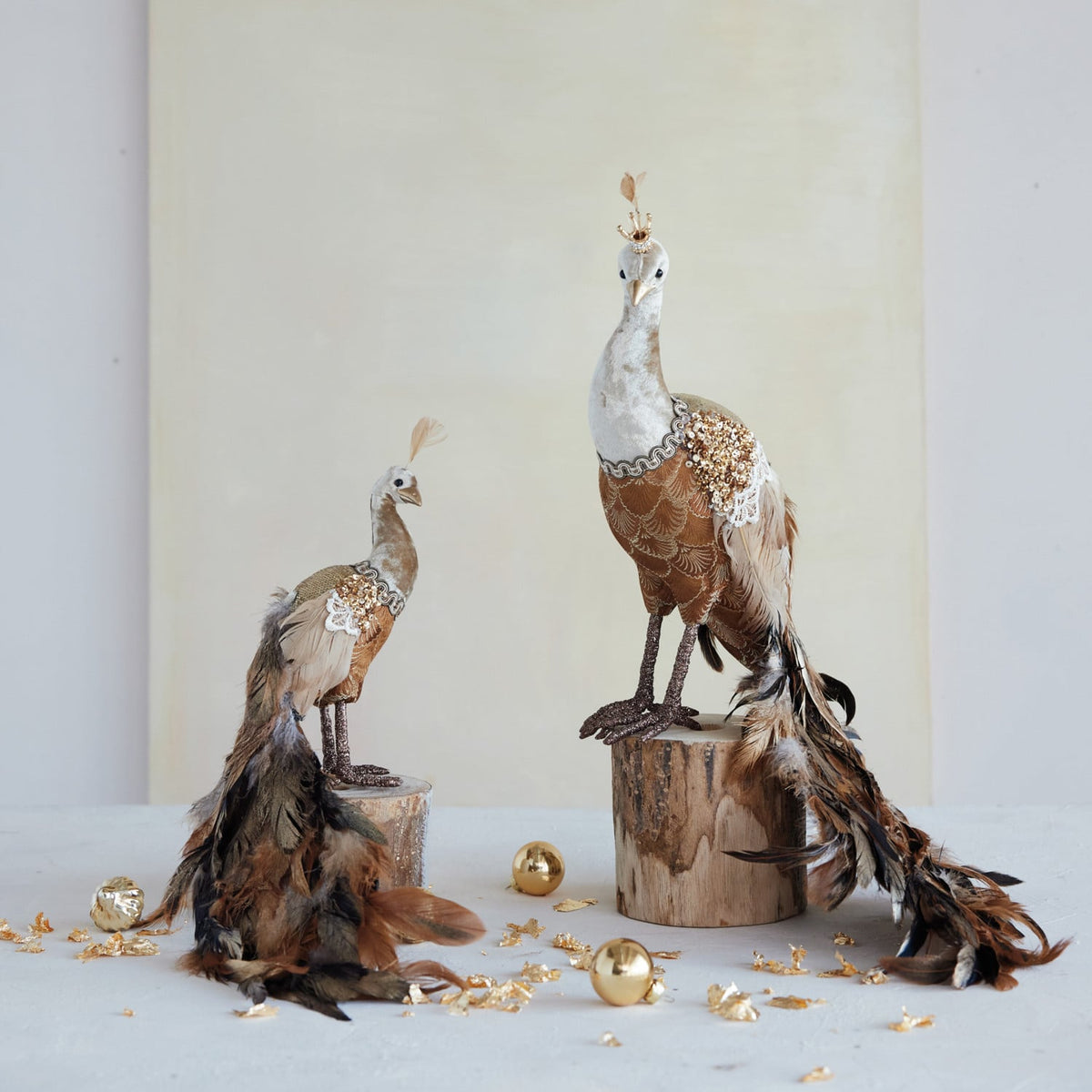 Sequin and Feather Peacock Figurine, Brown, A brown and gold peacock figurine with a long feathered tail trailing behind it and a small crown on its head, shown against a white background.
