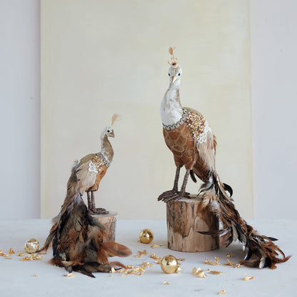 Sequin and Feather Peacock Figurine, Brown, A brown and gold peacock figurine with a long feathered tail trailing behind it and a small crown on its head, shown against a white background.