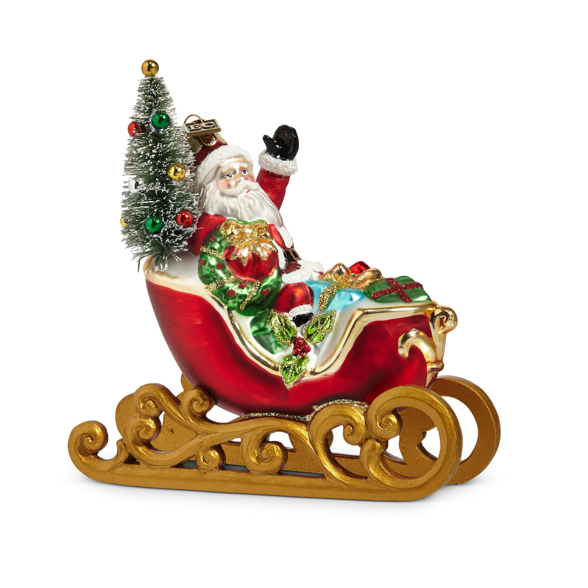 Sleigh Ride Ornament, A glass ornament of Santa riding in a red and gold sleigh loaded with a wreath, gifts, and a small frosted tree, with a brass EC tag.