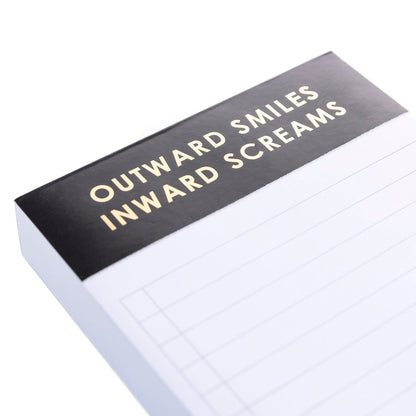 Smiles and Screams Jotter Notepad, A lined jotter notepad with a black header reading Outward Smiles Inward Screams in gold foil.